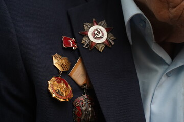 Badges and awards on the jacket of a World War II veteran.