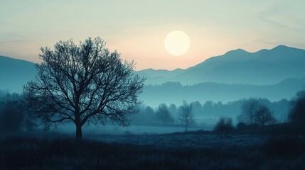 Fototapeta premium Early morning light casts a soft glow over a tranquil landscape with a lone tree silhouetted against the rising sun. Mountains stand serene in the background, enveloped in mist