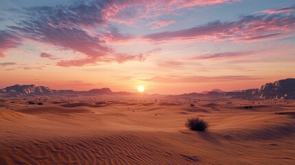 Golden rays of the sun illuminate the expansive sand dunes, while colorful clouds hover in the sky during sunset in a tranquil desert setting