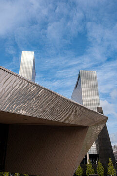 Modern architectural structure with angular concrete elements against blue sky.