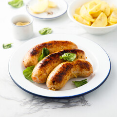 Homemade sausages served with potato salad