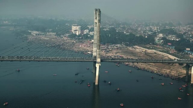 Cinematic aerial view of the New Yamuna Bridge, a stunning cable-stayed bridge in Prayagraj, Uttar Pradesh, India, captured during the grand Mahakumbh festival.