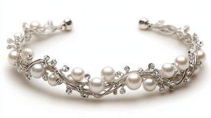 Obraz premium Silver and pearl bridal bracelet coiled in an elegant curve. A dainty silver bracelet adorned with pearls and crystal accents lies gracefully, reflecting soft light.