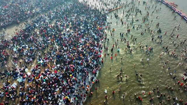 Aerial view of Huge crowd at Triveni Sangam in Prayagraj, India during Maha Kumbh. Kumbh Mela is the most important event, where millions of devotees, including Sadhu take a sacred holy dip in Ganga.