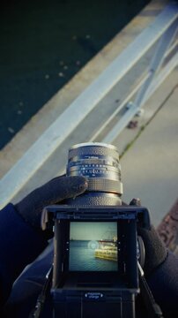 A Retro Viewfinder Capturing A Docked Ship In Calm Waters