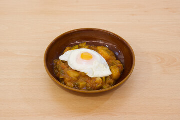 A bowl of food with a fried egg on top