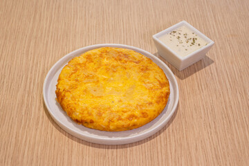 A plate of food with a yellow dish on it