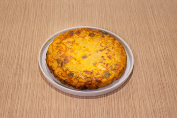 A plate of food with a yellow and brown dish on it
