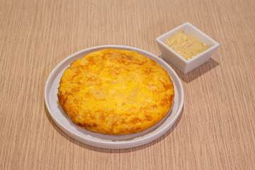 A plate of food with a yellowish brown dish on top of it
