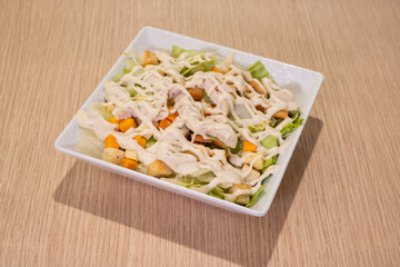 A white plate with a salad on it