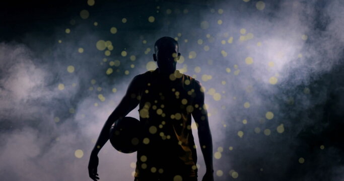 Image of light spots over african american male basketball player