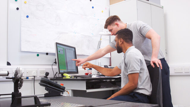 Two Male Engineers Uses CMM Coordinate Measuring Machine In Factory