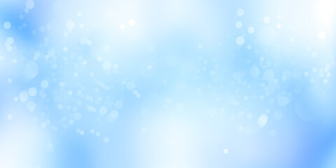 Obraz premium Soft blue abstract background with light bokeh effects for creative projects and designs.