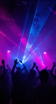 Colorful laser lights create dynamic atmosphere at nightclub dance event in the evening. Vertical HD background.