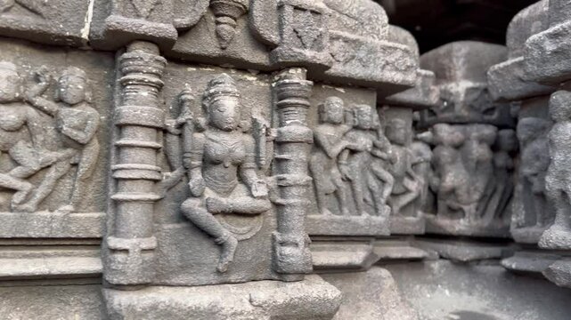 Hindu deities carved beautifully on exterior walls of ancient temple in India