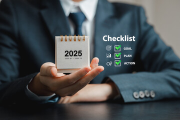 Businessman Holding 2025 Calendar with Checklist for Success