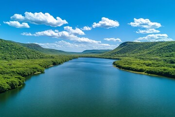 Stunning panoramic view of a summer river surrounded by green forest and hills under blue skies