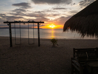 Beach swings in Dreamshore Kiwi Beach Resort with sunset background. Santa Fe, Tablas, Romblon....