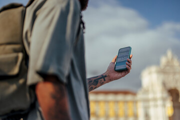 Tourist using navigation app on smart phone in lisbon, portugal