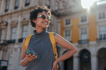 Tourist with backpack and smart phone exploring european city