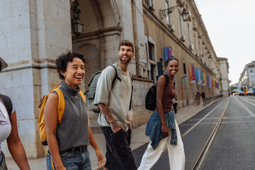 Happy tourists walking and laughing in lisbon city center