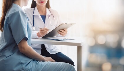 female doctor with a clipboard - nurse sitting next to her