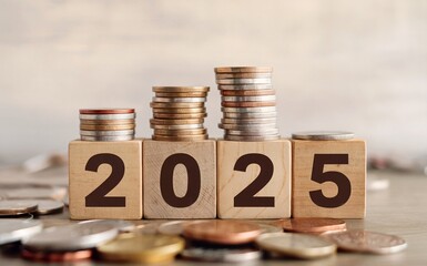 Stacks of Coins with Wooden Blocks Spelling 2025 Reflecting Future Finance