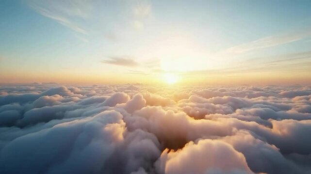 View of clouds from a height, through which the light of the sun breaks through. The sun is on the horizon, creating a warm glow and coloring the clouds in soft shades of orange and pink.