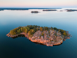 Rocky island on a beautiful summer evening in calm, aerial view