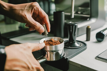 Close-up of coffee powder spreading in the brewing handle to prepare a coffee drink menu.