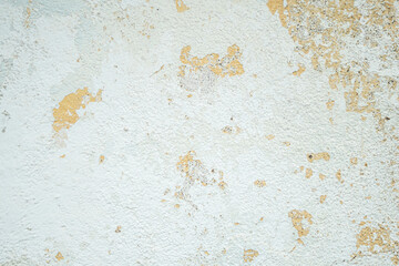 Crumbling plaster on a painted wall as a background.