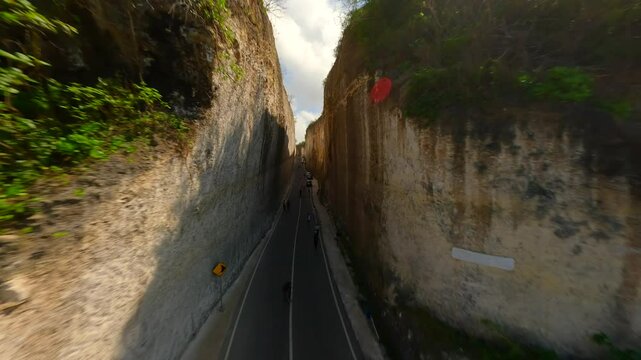FPV flight over the road in limestone cliffs near Batu Barak beach in Bali, Indonesia
