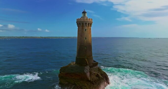 Aerial view. A rotating flight above Phare du Four a lighthouse in Brittany, France