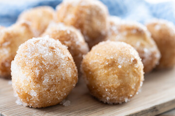 Traditional Carnival fritters or buñuelos de viento on wooden table. cvLOSE UP
