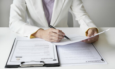 Business woman employer holding resume hiring recruit looking cv resume to hire candidates, analyzing information before job interview. Recruitment concepts