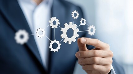 Businessman in suit interacting with virtual gears, symbolizing teamwork, innovation, and business strategy.