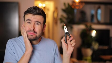 Man removing his own tooth