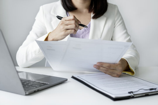 Business woman employer holding resume hiring recruit looking cv resume to hire candidates, analyzing information before job interview. Recruitment concepts