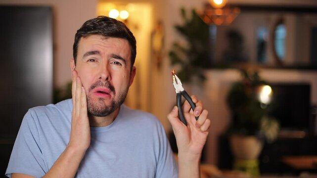 Man removing his own tooth 