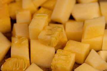 diced soft ripe pumpkin of orange color, fresh pumpkin for cooking