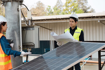 Inspecting solar panels for sustainable energy solutions. Engineers working on solar technology at...