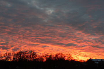 Fiery Sunset Over a Dark Silhouette