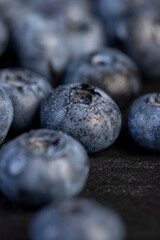 a pile of blueberries scattered on the board