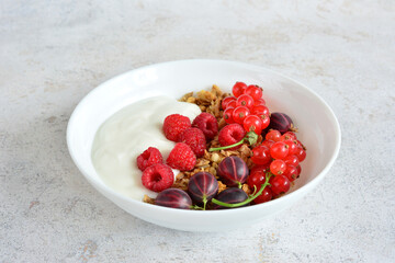 Yogurt Granola Parfait with current, gooseberry and raspberry