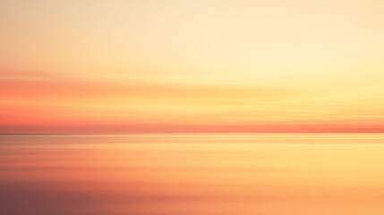 Fototapeta premium Tranquil sunset over calm ocean reflecting warm golden and orange hues