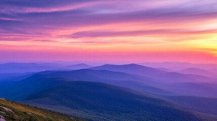 Obraz premium A stunning and dramatic sunset sky over the mountains, showcasing vibrant and colorful hues of orange, purple, and pink as the sun sets behind the peaks, creating a breathtaking natural landscape