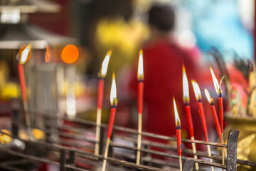 Red Incense Sticks in a Temple Ritual, Close-Up of Spiritual Practice at a shrine