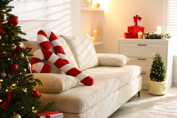 Candy cane pillows and other Christmas decor in room. Festive interior design