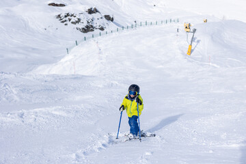 Happy family with children, school kids in winter ski resort, skiing winter time