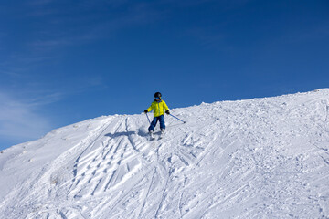 Happy family with children, school kids in winter ski resort, skiing winter time